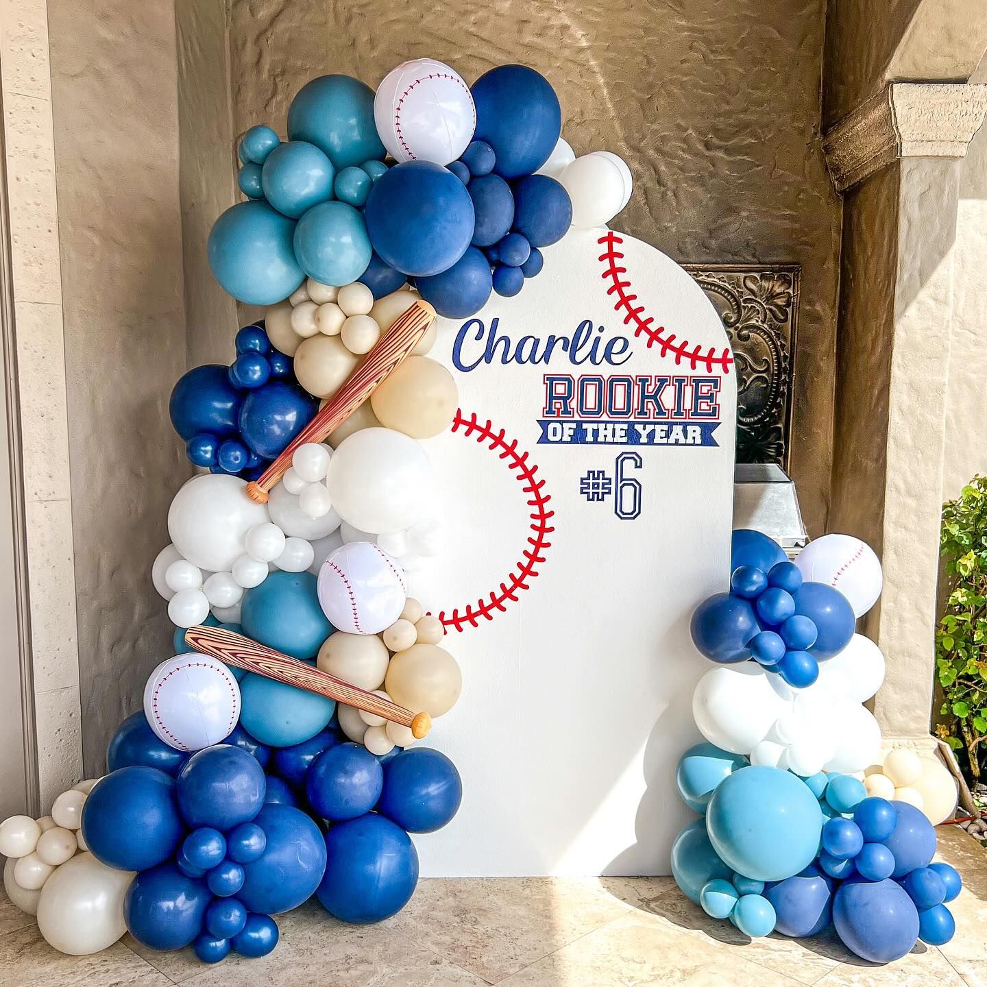 A bunch of blue and white balloons are stacked on top of each other.
