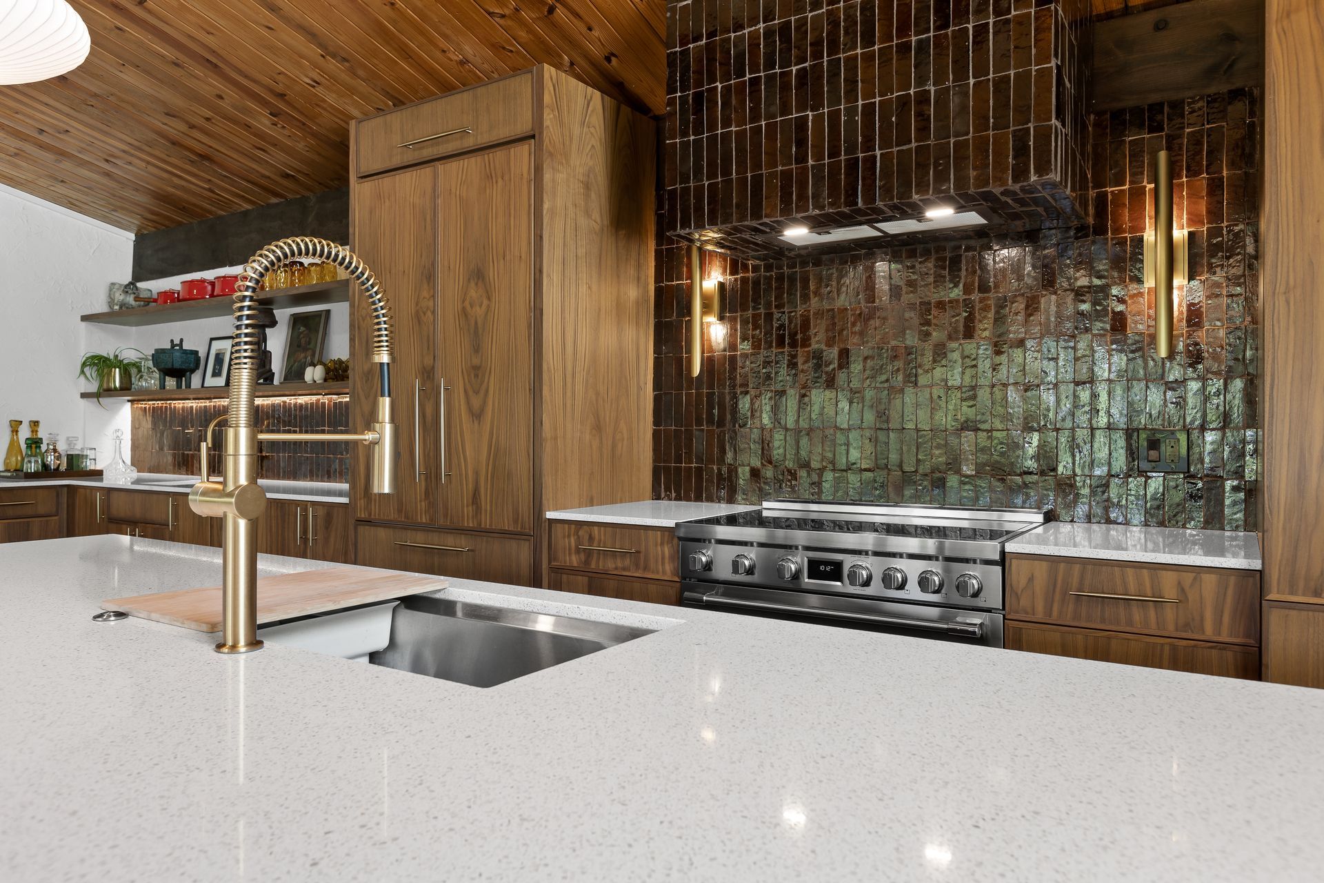 Modern kitchen with wooden cabinets, stainless steel appliances, and a white countertop.