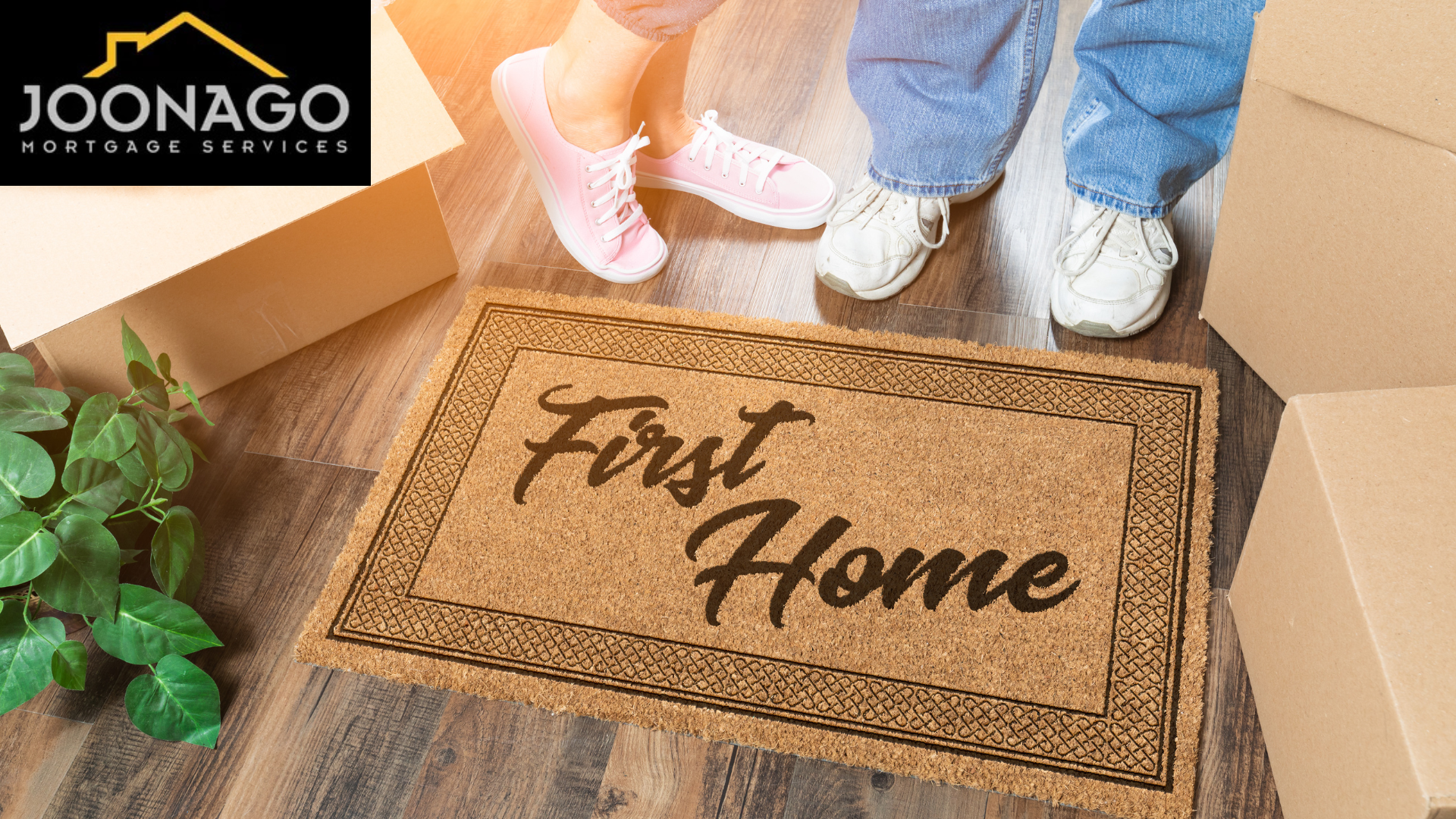 A couple standing next to a door mat that says `` first home ''.