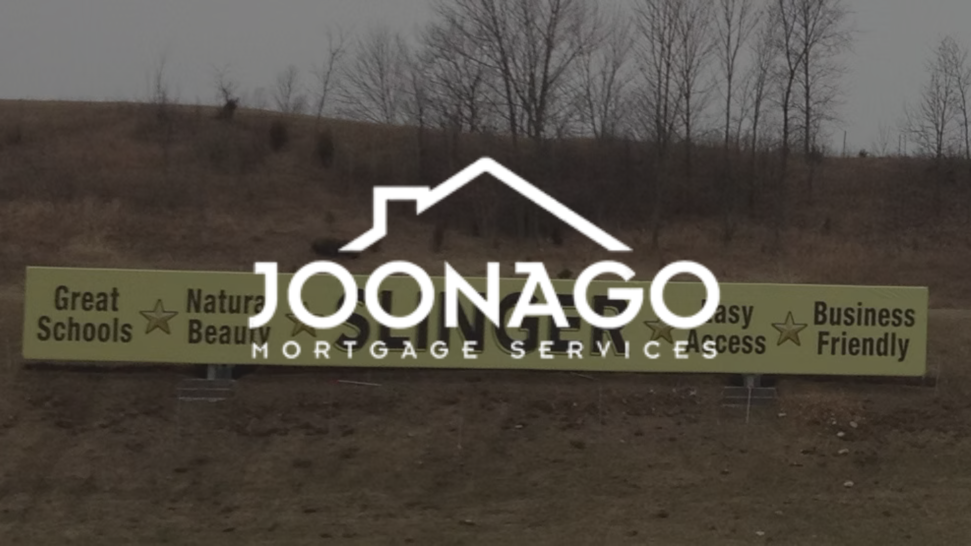 Billboard for Joonago Mortgage Services with a house logo and text against a landscape backdrop.