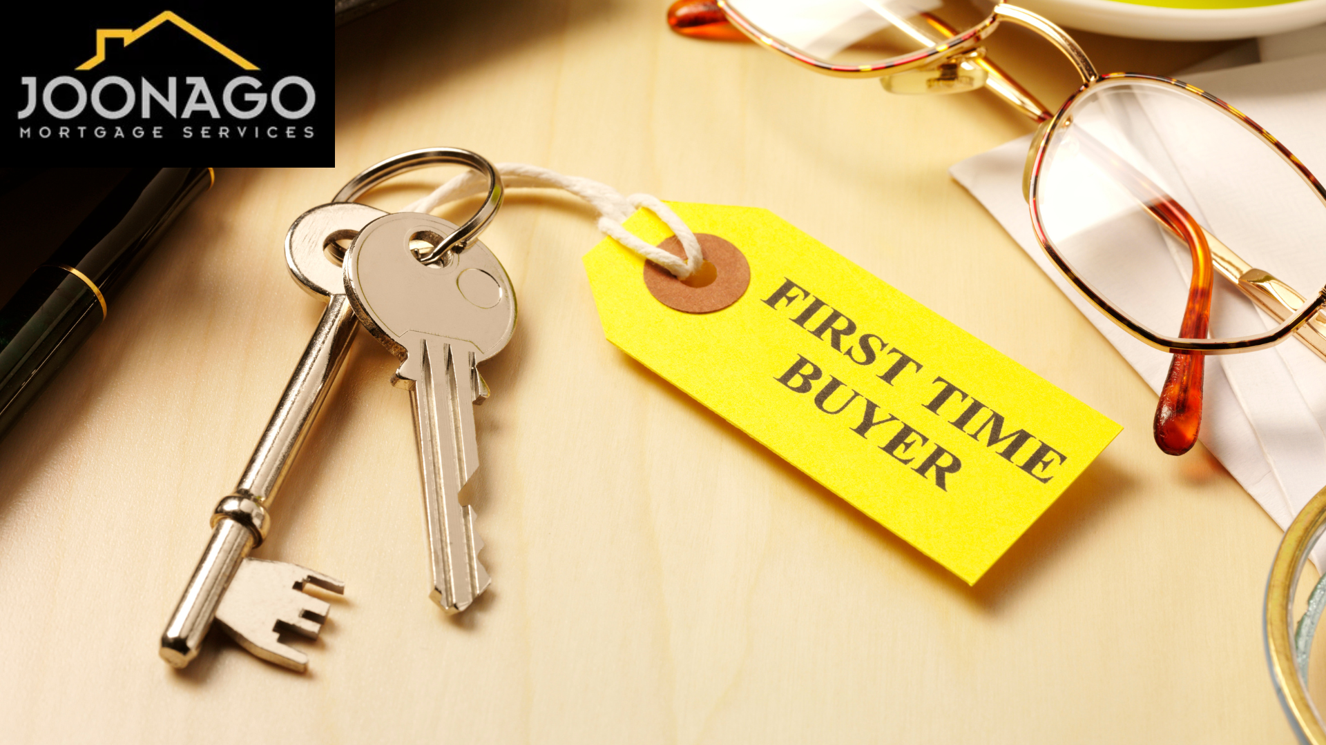 A pair of keys with a yellow tag that says first time buyer