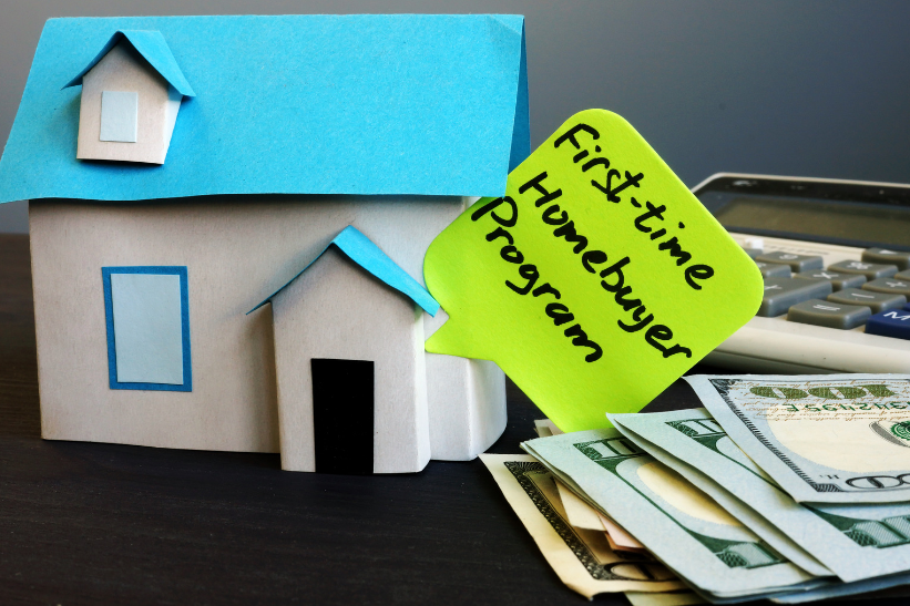 A model house with a sticky note that says first-time homebuyer program