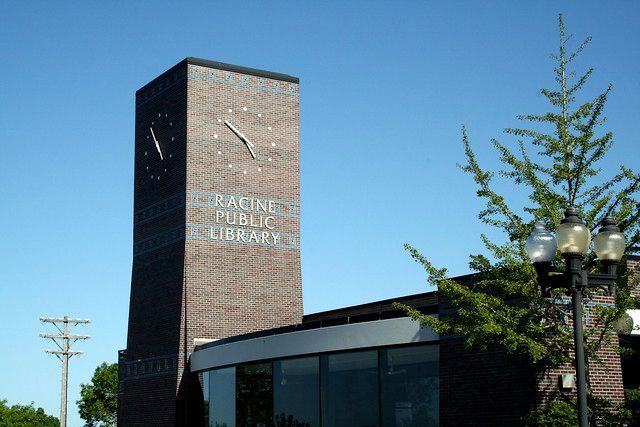 A building with a clock tower that says racine public library