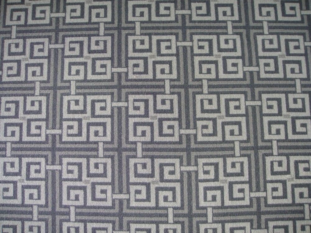 Geometric patterned fabric in white, gray, and black.