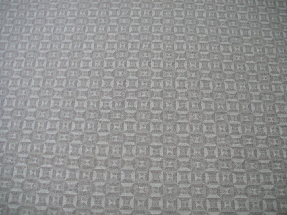 Geometric blue and white pattern with diamonds and angled lines.