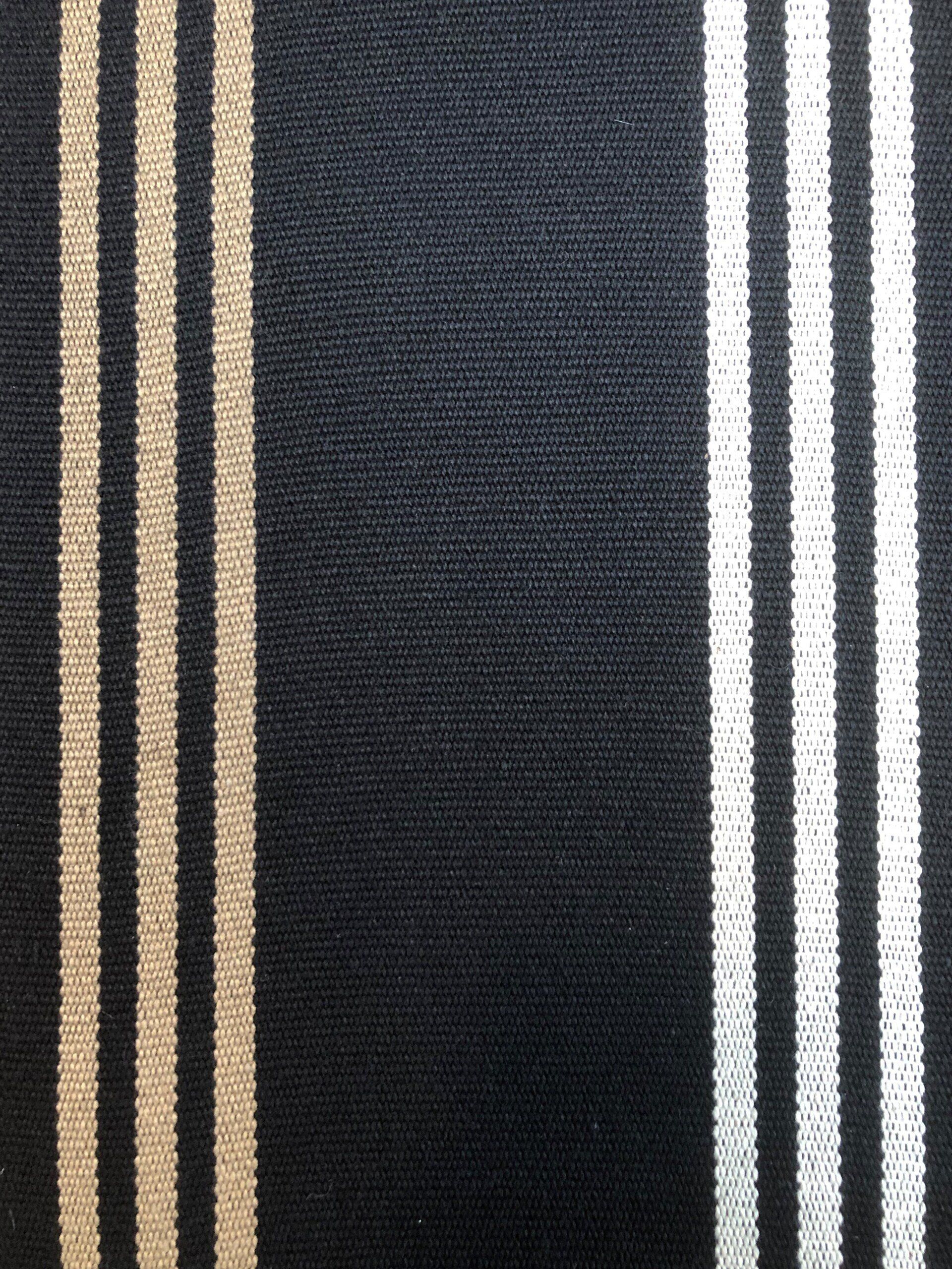 Black fabric with vertical stripes in beige and white.