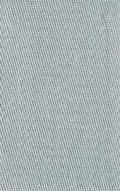 Close-up of light blue denim fabric with visible woven texture.
