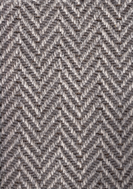 Herringbone pattern carpet in shades of gray and white.