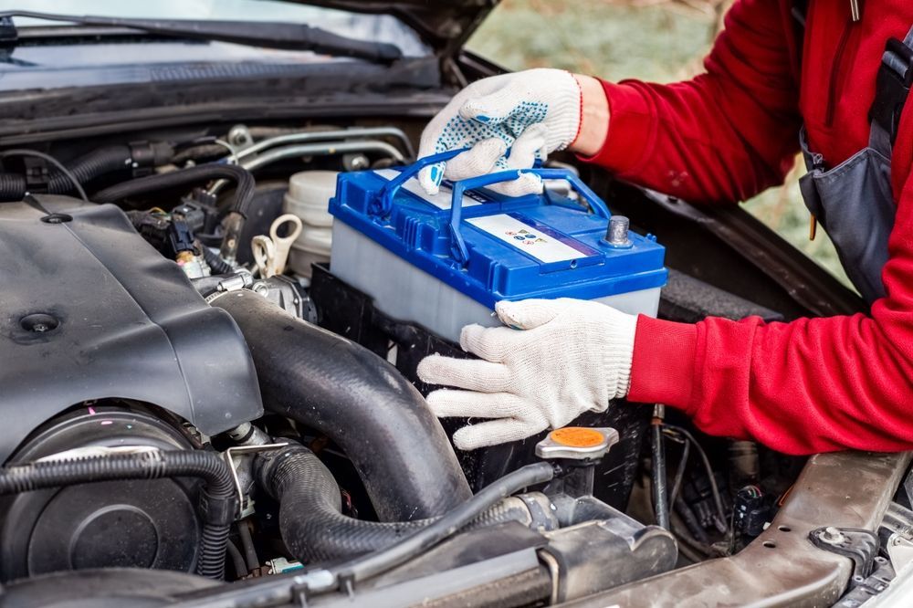 Car Mechanic Installing Car Battery - Auto Electrical Service in Garbutt, QLD
