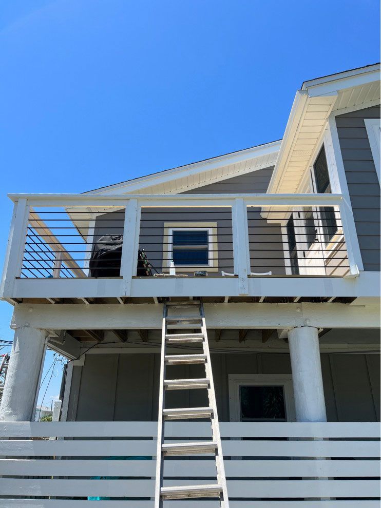 A second story deck of a house.