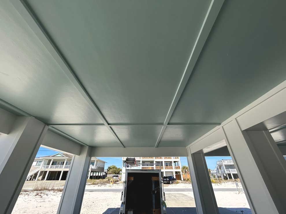 Looking up at the ceiling of a building with houses in the background