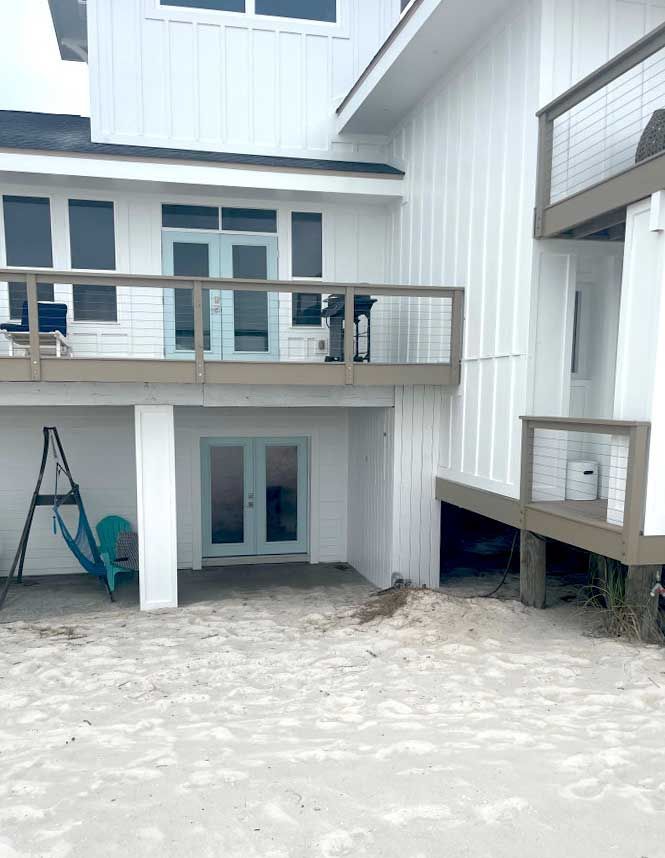 A white house with a large deck.