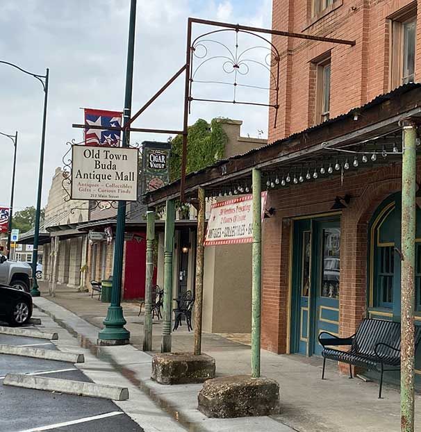 A brick building with a sign that says old town buds antique mall