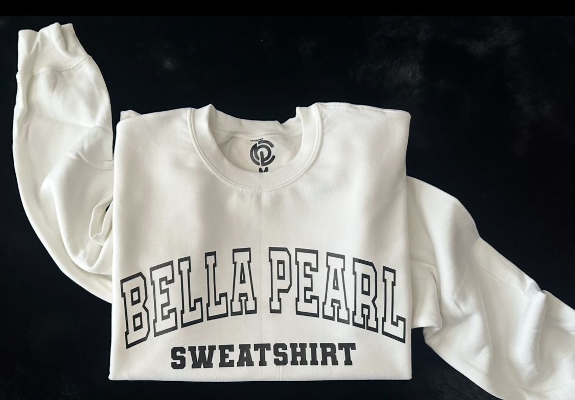 A white bella pearl sweatshirt is folded up
