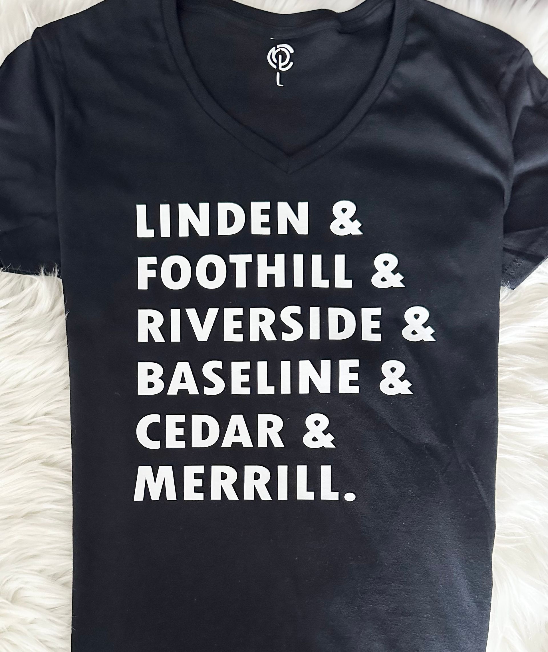A black t-shirt says linden & foothill & riverside & baseline & cedar & merrill