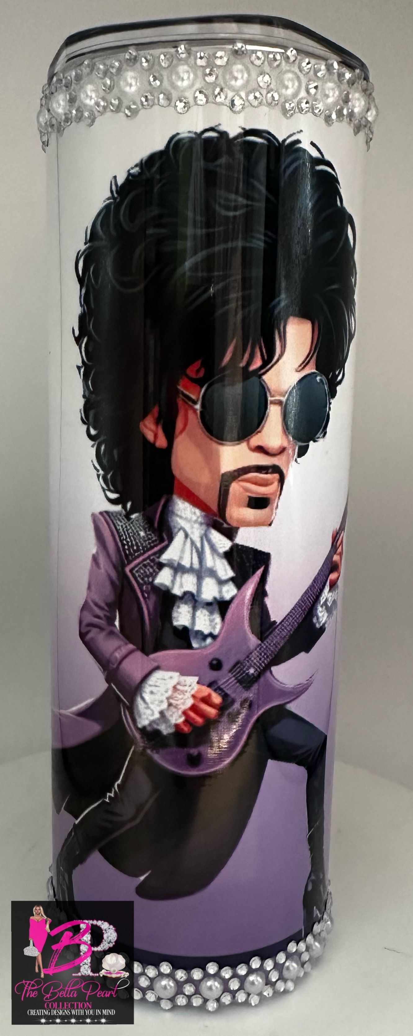 A tumbler with a cartoon of prince playing a guitar.
