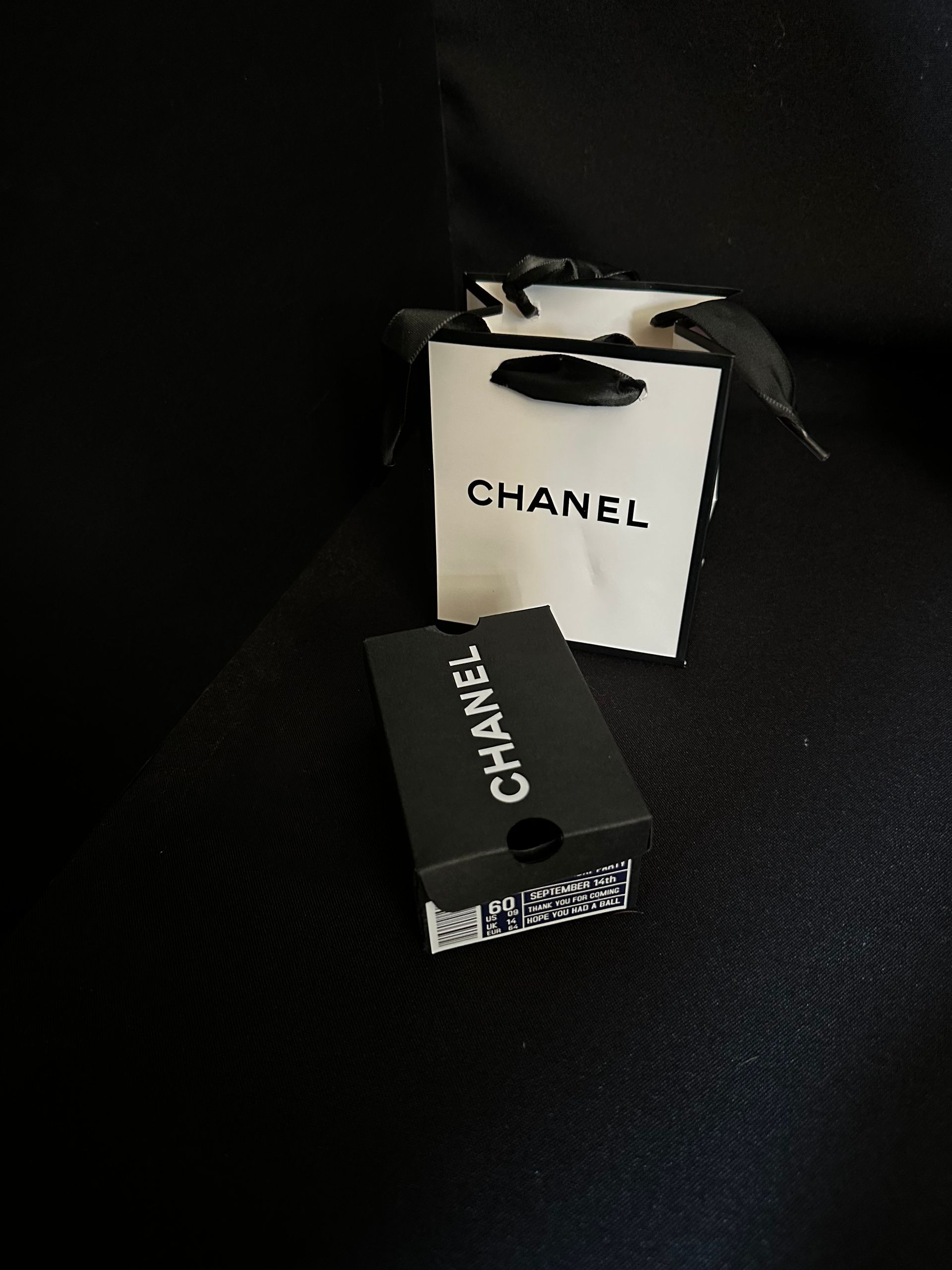 A black and white themed chanel favor bag and shoebox