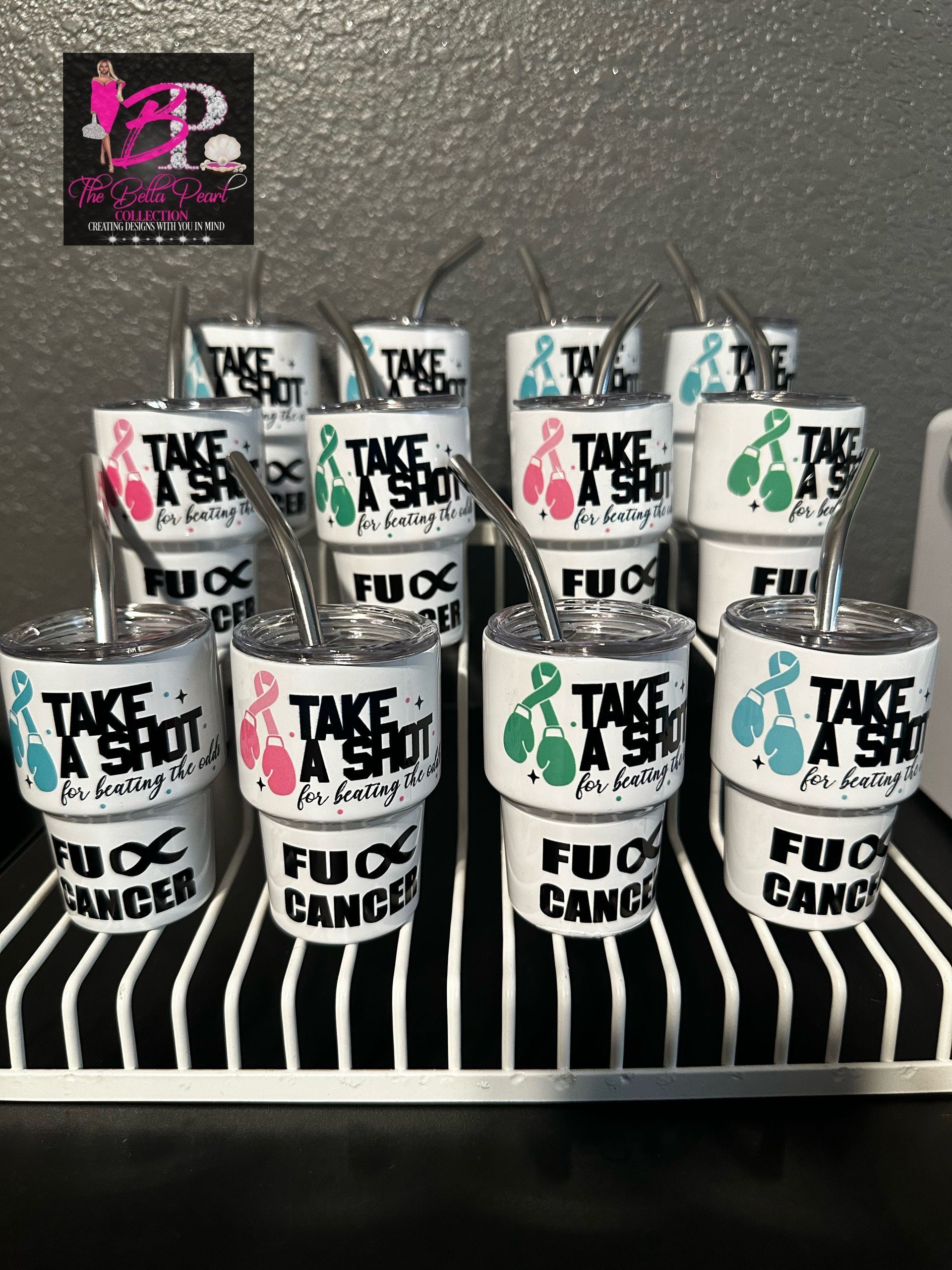 A group of mini shot tumblers saying take a shot with straws