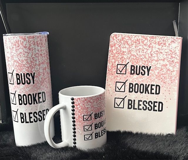 A tumbler a mug and a notebook with a woman on them