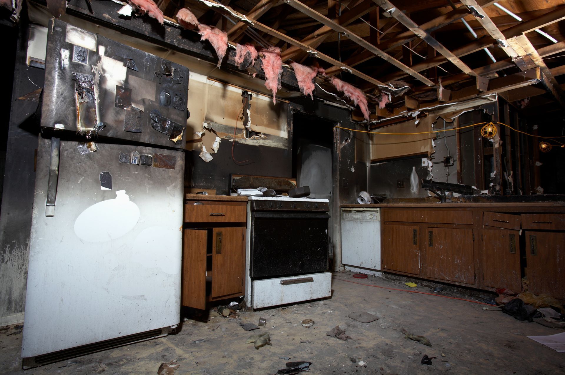 A kitchen in an abandoned house with a stove and refrigerator
