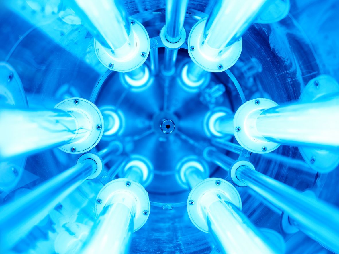 Blue glowing fluorescent tubes arranged in a circular pattern, viewed from below