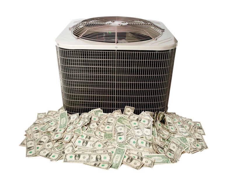 Air conditioner with a pile of dollar bills in front of it