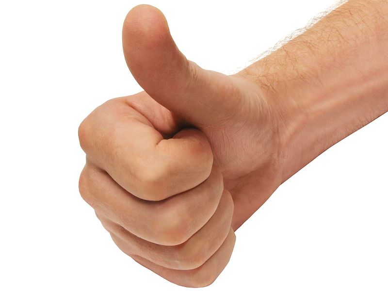 Hand giving a thumbs-up gesture on a white background