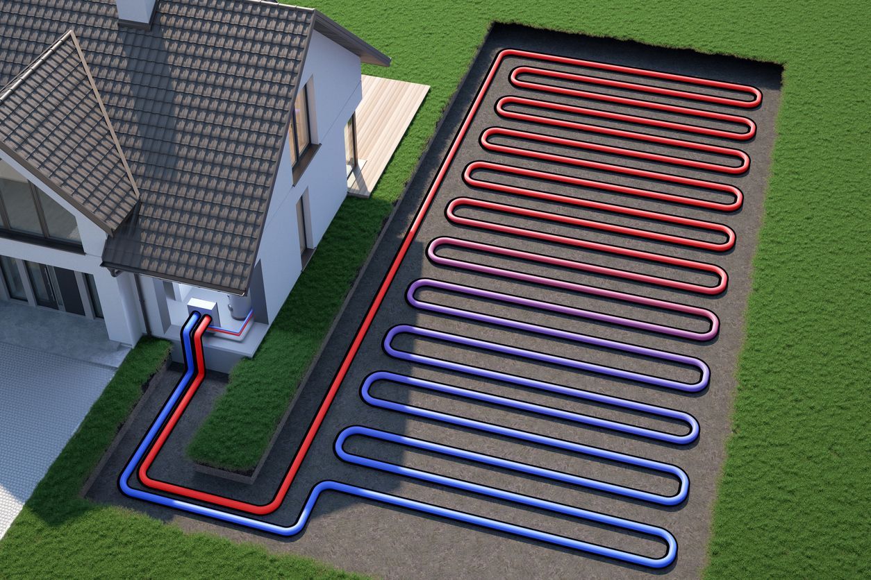 House exterior with red and blue piping laid in looping trenches across a grassy yard