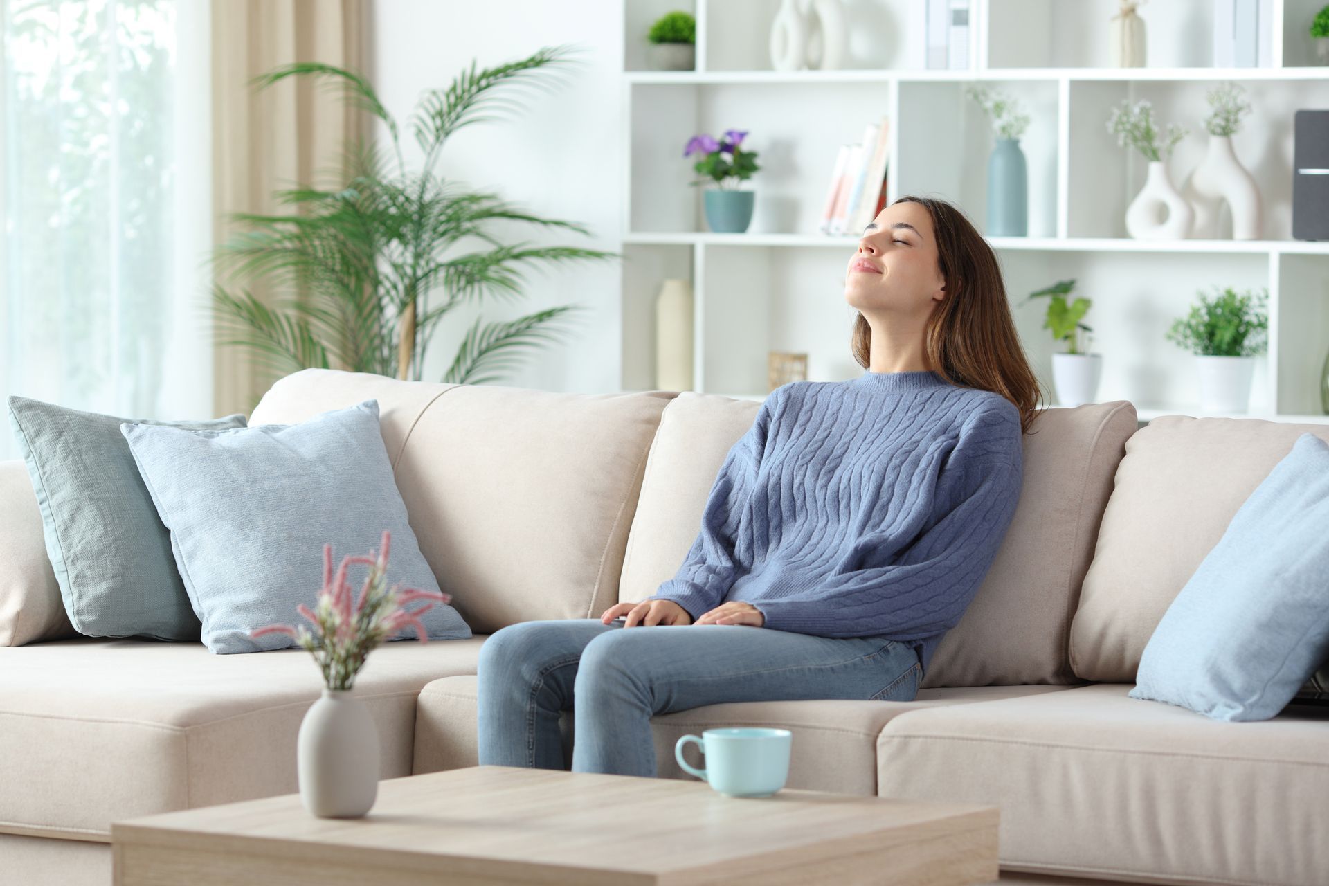 Relaxed woman breathing fresh clean indoor air in Orlando Florida home with air purifier system.