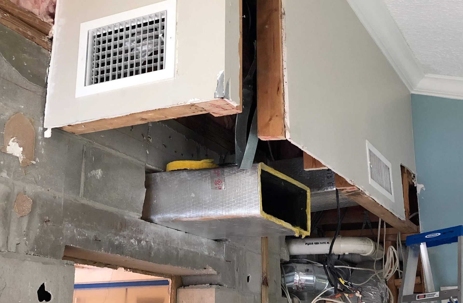 HVAC ductwork and vents in an unfinished ceiling space