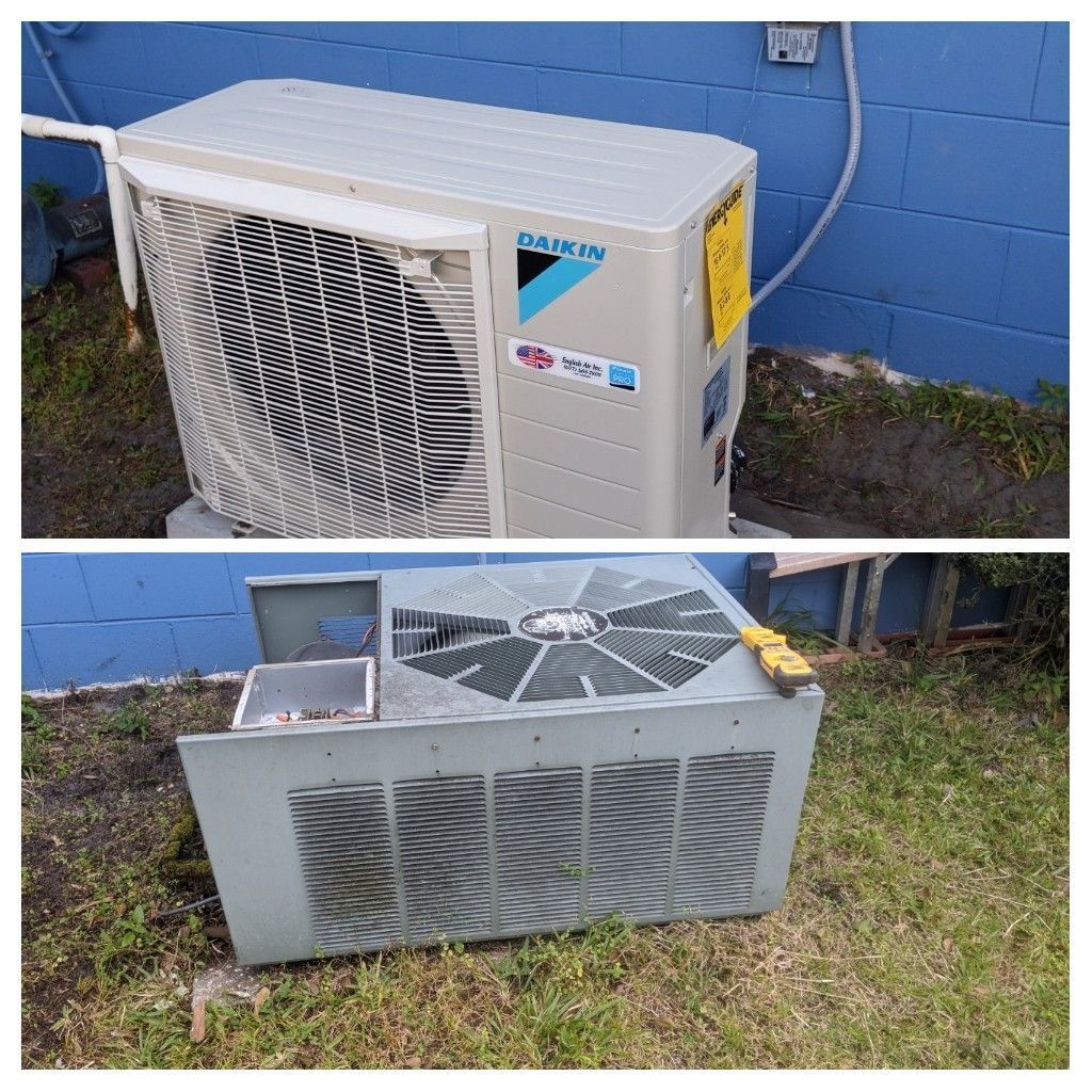 Two outdoor HVAC units beside a blue wall, one new-looking and one damaged with the top removed.