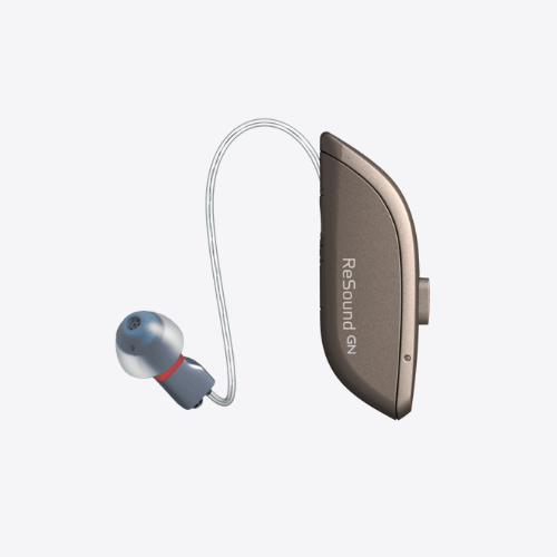 Behind-the-ear hearing aid with beige body and blue earbud on white background