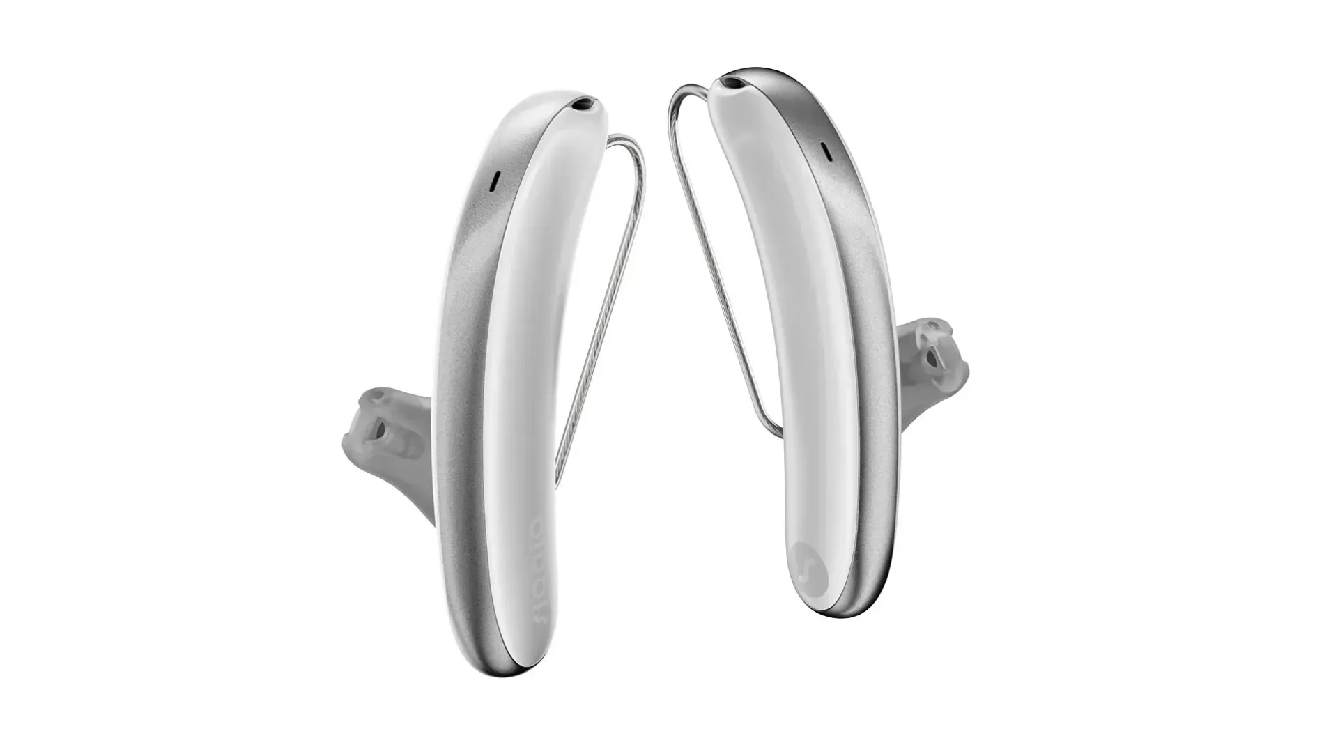 Pair of white behind-the-ear hearing aids with thin connecting cords on a white background