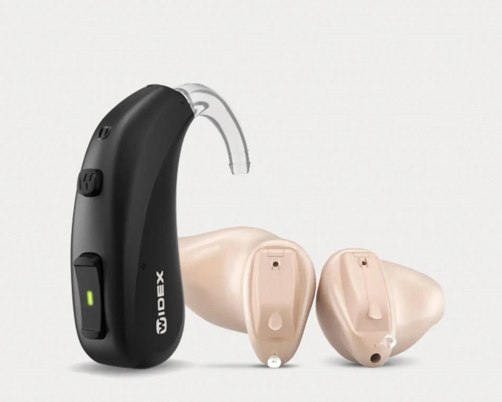 Black behind-the-ear hearing aid with two beige earpieces on a white background