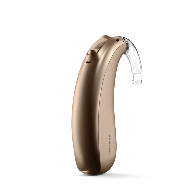 Beige hearing aid device with clear ear tube, isolated on white background
