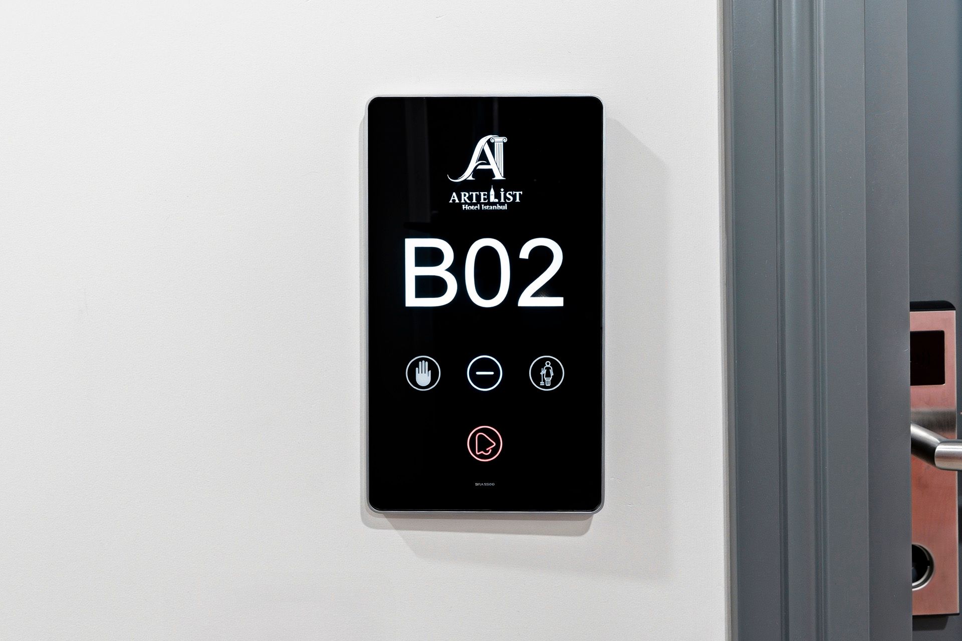ARTELIST HOTEL | Black elevator floor display showing B02 with buttons on a wall panel