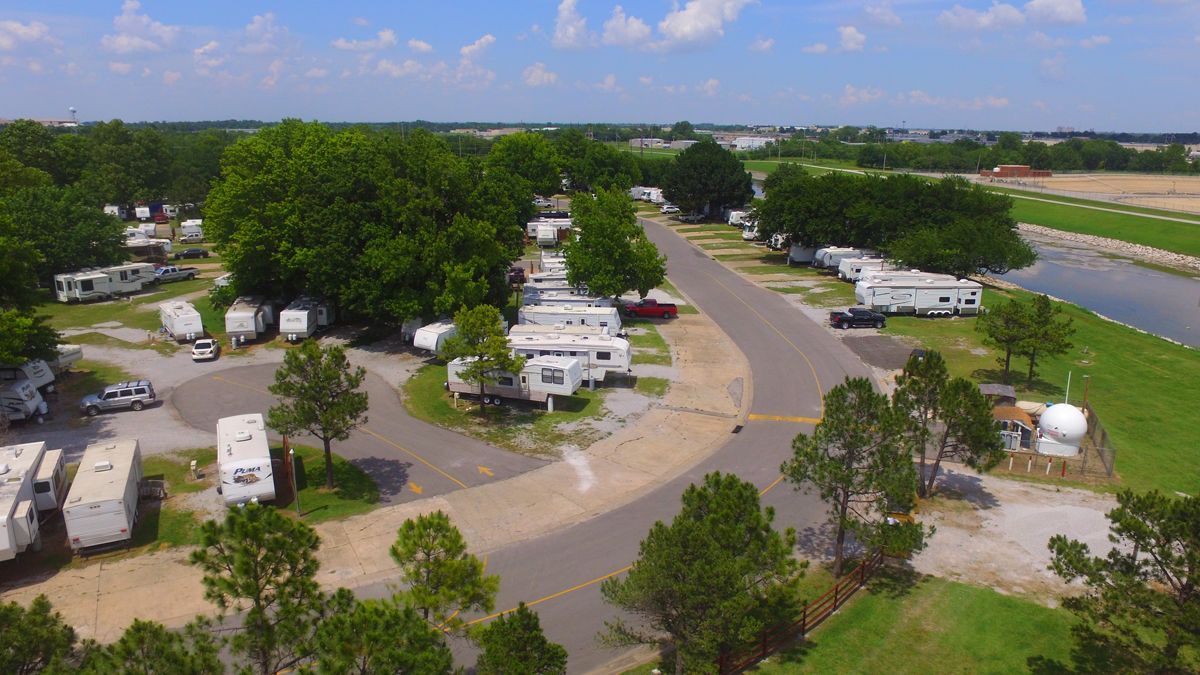 An aerial view of a rv park with a river in the background.