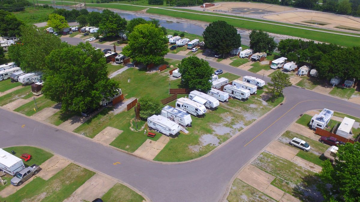 An aerial view of a campground with a lot of rvs parked in it.