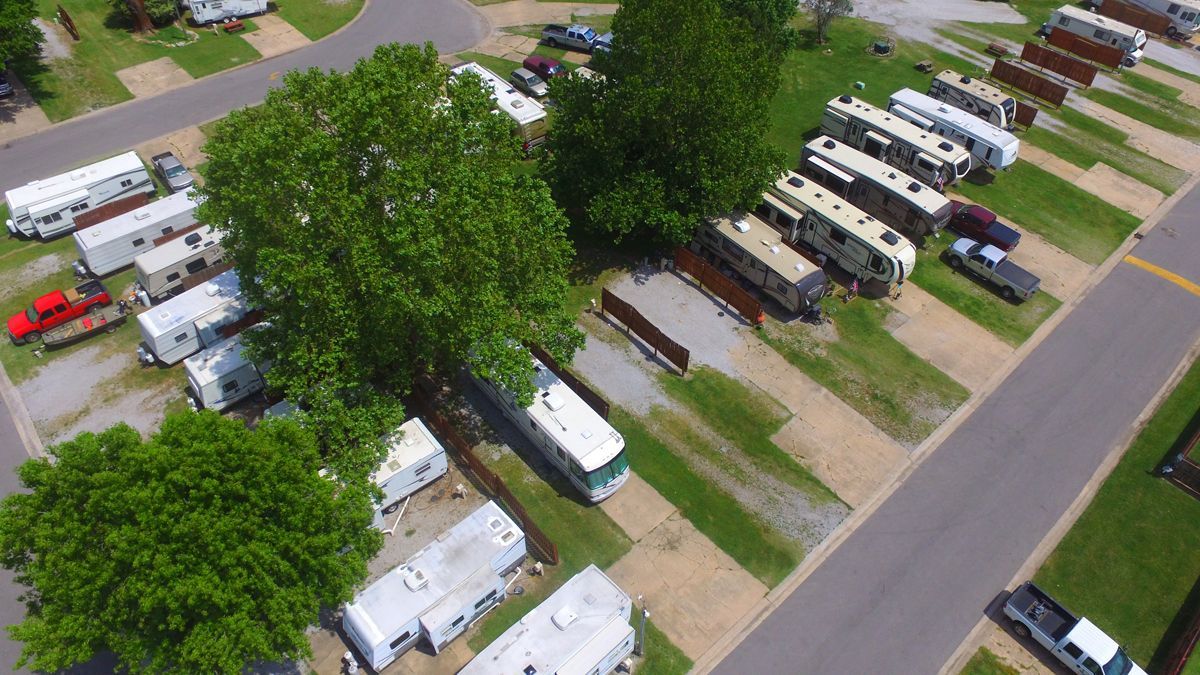 An aerial view of a row of rvs parked in a parking lot.