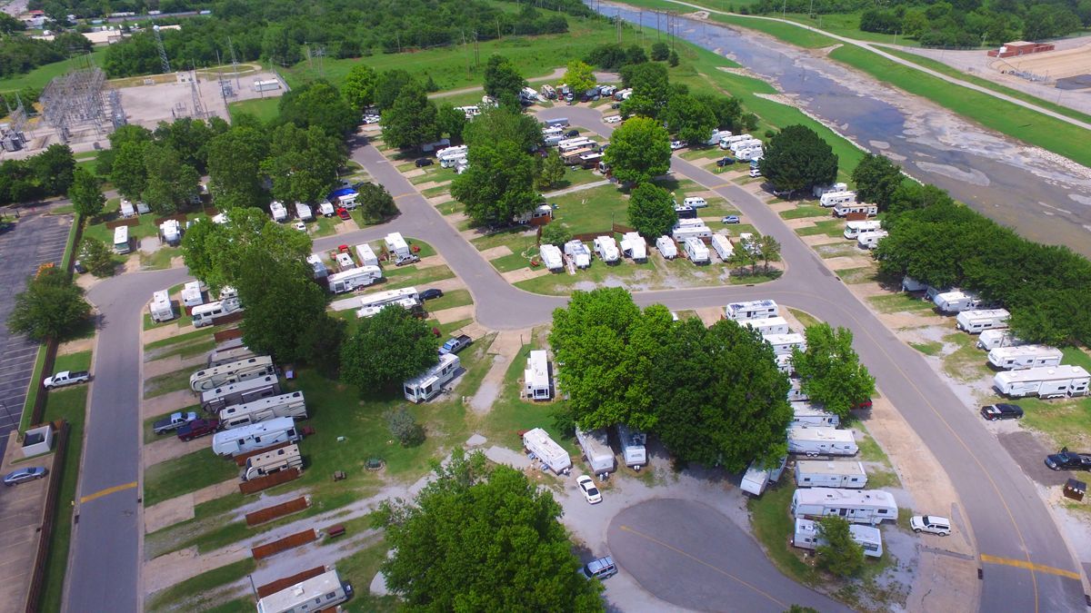 An aerial view of a campground with a river in the background.