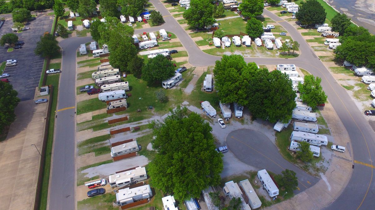 An aerial view of a campground filled with rvs and trees.