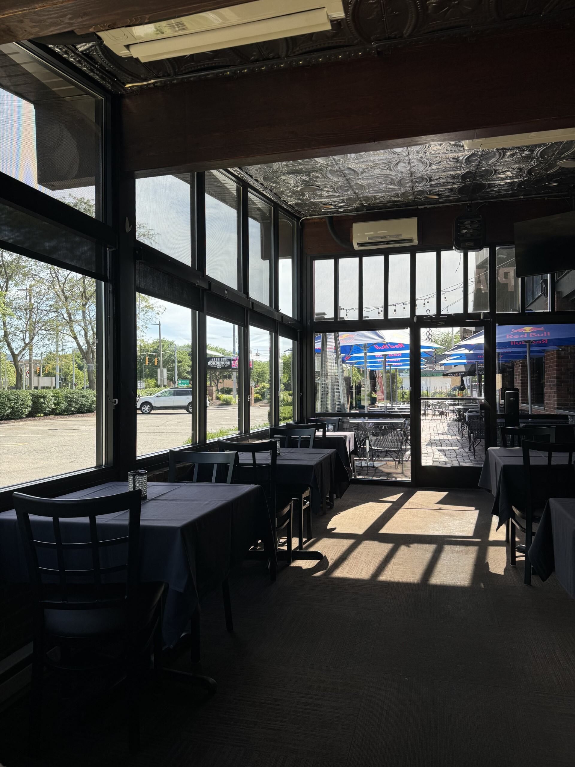 A restaurant with tables and chairs and lots of windows