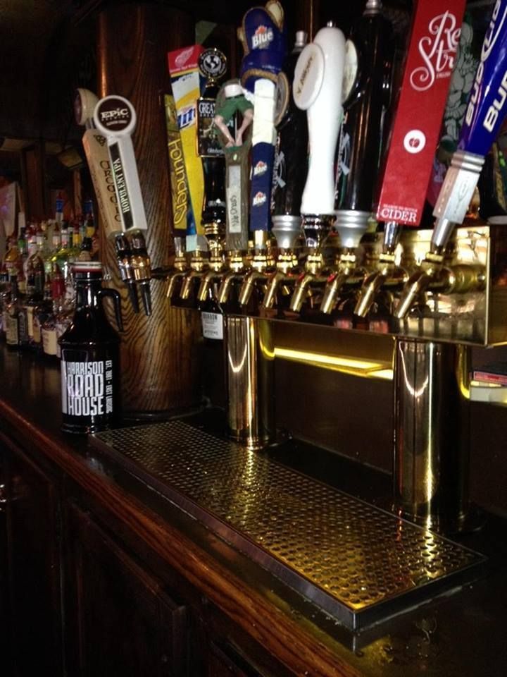 A bar with a lot of beer taps and bottles