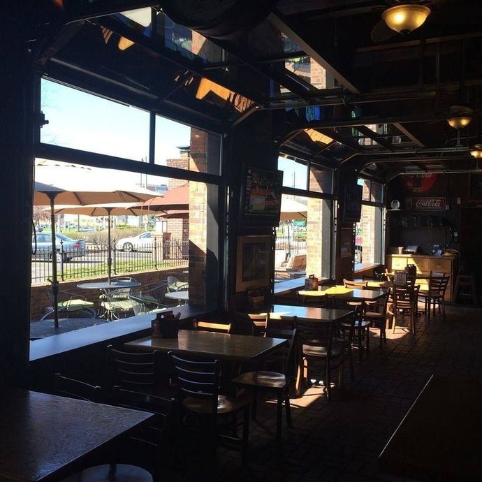 The inside of a restaurant with tables and chairs