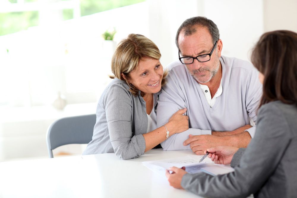 A Couple Signing Financial Contract — Clarence Property Consultants In Grafton, NSW