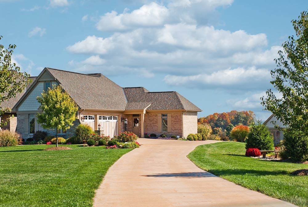 A Large Brick House With a Driveway Leading to It — Clarence Property Consultants In Wooli, NSW