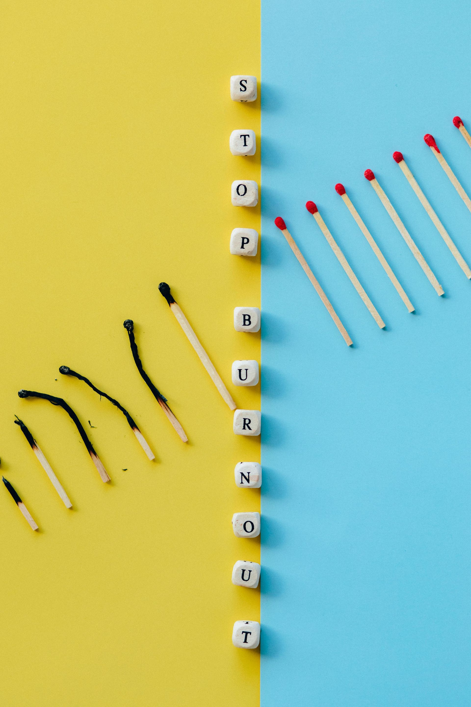 Burnt matches next to unlit matches; yellow and blue background; words 