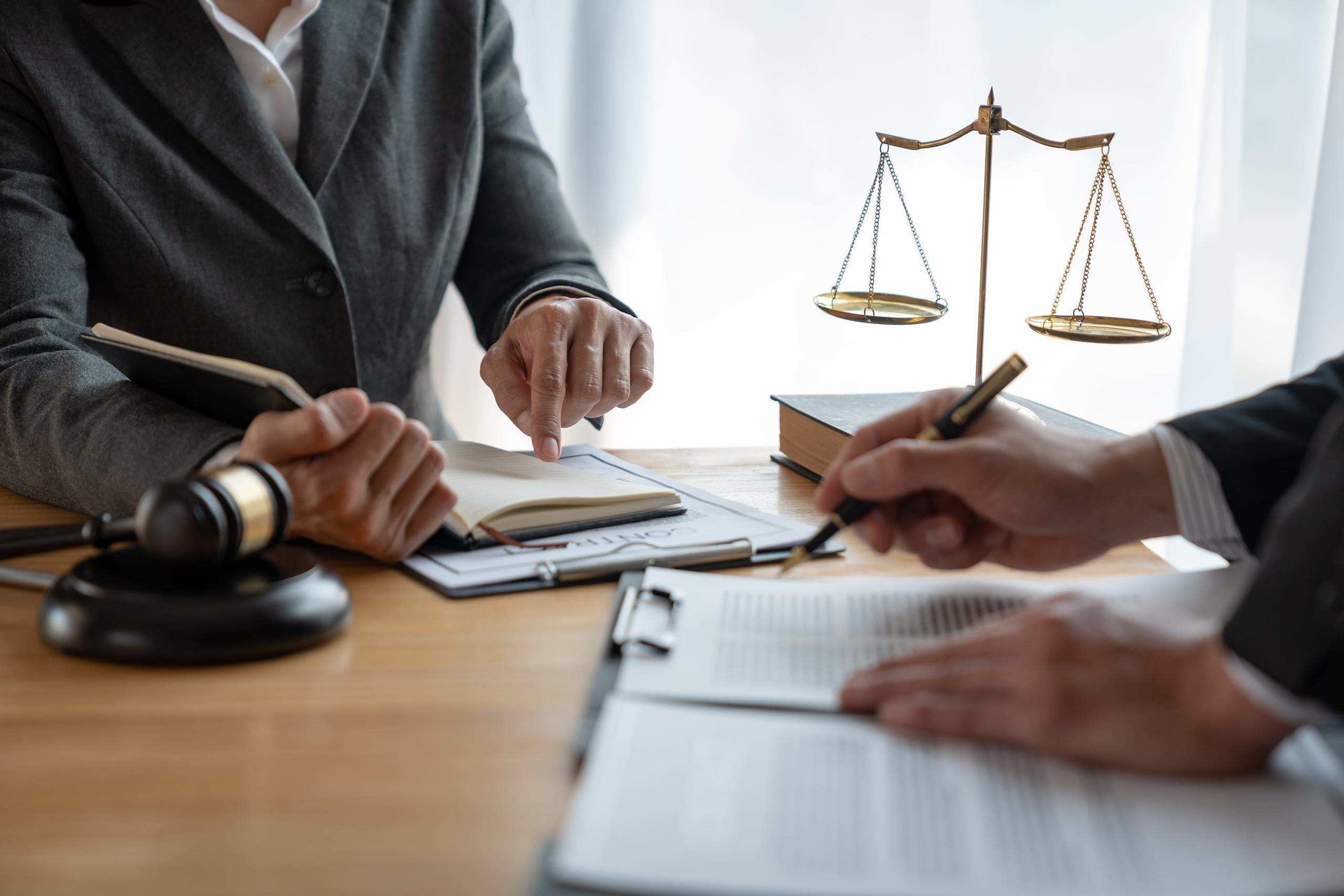 Lawyers Reviewing Documents at A Desk with A Gavel — Bradley Solicitors in Larrakeyah, NT