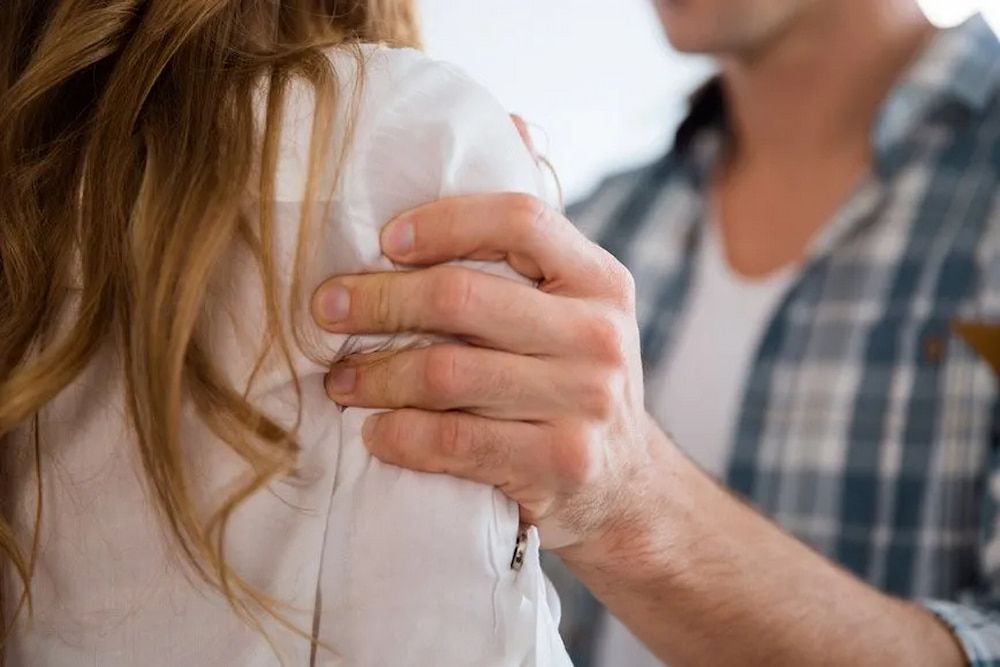 Man's Hand on a Woman's Shoulder, Offering Comfort or Support — Bradley Solicitors in Larrakeyah, NT