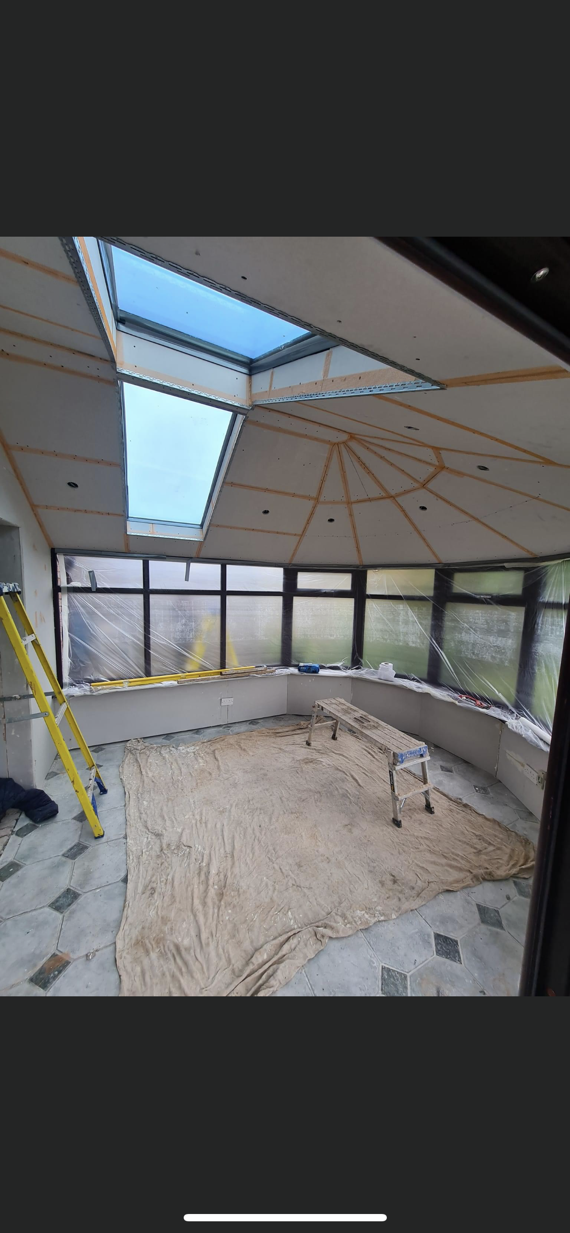 A room with a lot of windows and a skylight in the ceiling.